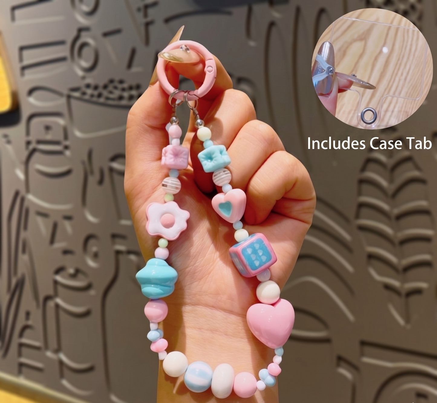 Colorful beaded case tab held by a hand with a textured background