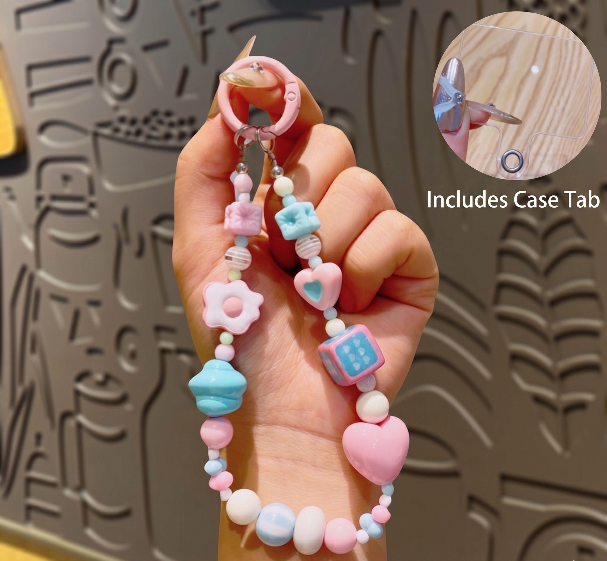 Colorful beaded case tab held by a hand with a textured background