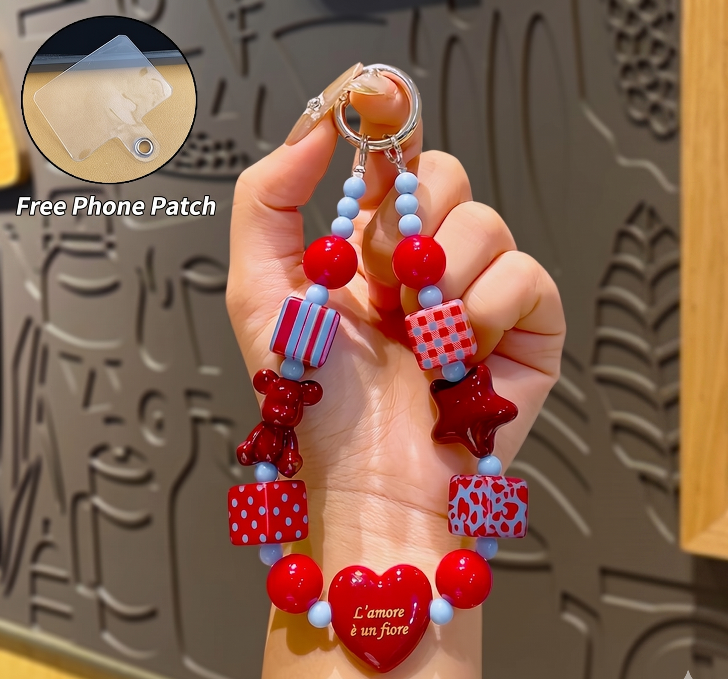 Hand holding a colorful beaded bracelet with a heart charm, against a textured gray background.