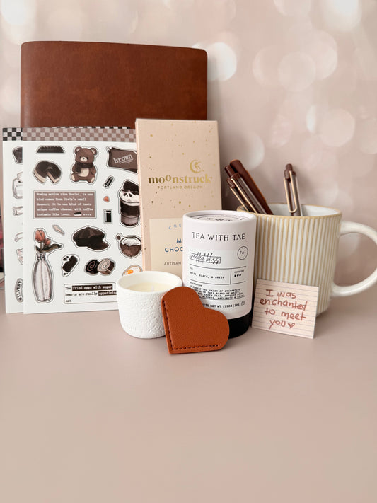 Hygge gift box with soy candle, oolong tea, dark chocolate, vintage journal — cozy self-care birthday gift under $50